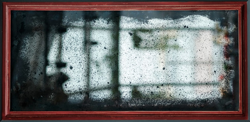 old vintage mirror with scratches and dust.