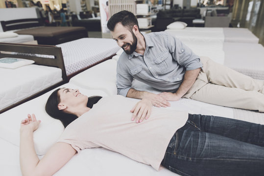 The couple came to a large mattress store to choose their own mattress. They lay down on one of them