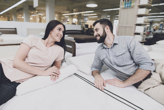 The couple came to a large mattress store to choose their own mattress. They lay down on one of them