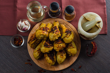 grilled chicken legs on wooden background