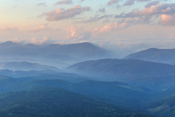 mountain ridges in a blue mist at the evening