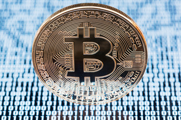 Bitcoin close-up on white binary code background