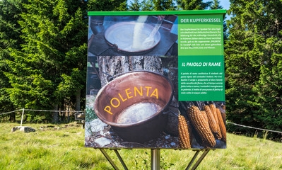 billboard dedicated to polenta recipe. Mountain symbol and South Tyrolean tradition. South Tyrol,...