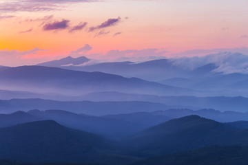 Obraz na płótnie Canvas evening mountain valley in a blue mist