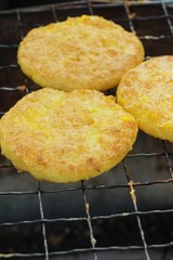 Grilled sticky rice with egg plating on stove