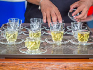 Preparing glasses of tea for serving customer.