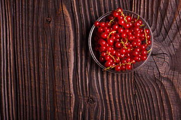 fresh red currant and jam on the rustic background