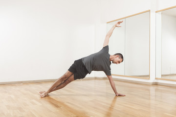 Fototapeta premium Pilates instructor performing fitness exercise at the gym indoor
