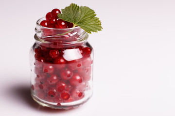 fresh red currants and jam on a white background