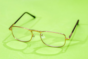 Glasses isolated on green background close up