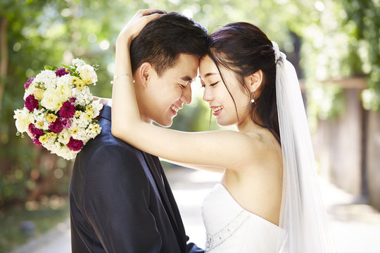outdoor portrait of a happy asian wedding couple