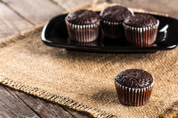 Chocolate muffins on wooden table