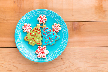 Christmas homemade snowflake  and christmas tree cookies on plate.