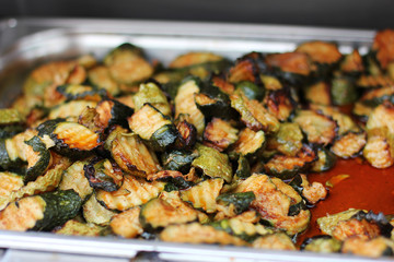 Slices of grilled zucchini with sauce