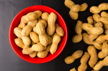 Peanuts in shell on dark background, close up