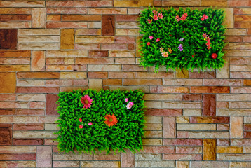 Fototapeta na wymiar Garden Patches on Brick Wall