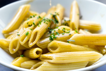 Pasta with pesto sauce and nuts on a the table