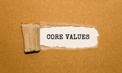The text CORE VALUES appearing behind torn brown paper