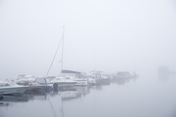 Boats in a foggy harbour in Kuopio, Finland