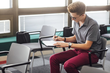 Male Student Taking Notes