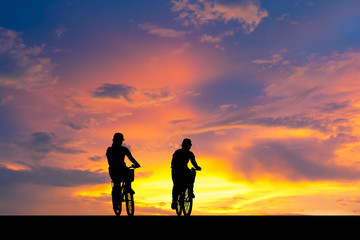 Silhouette image. Shadow of woman riding bike.