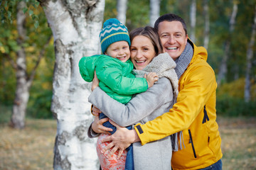 Happy family playing in autumn park