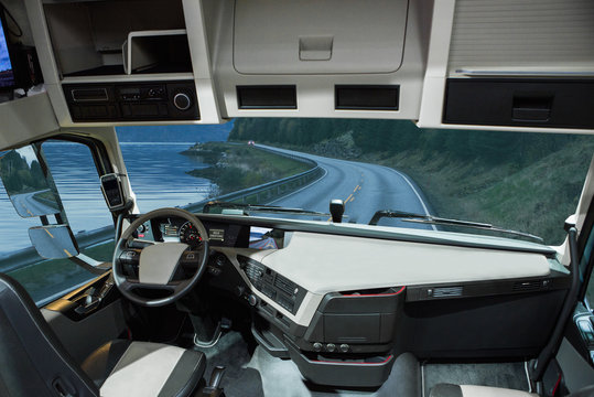 Self driving truck without driver on a road. Inside view.