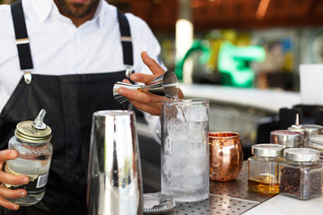 barman pouring alcohol in a glass