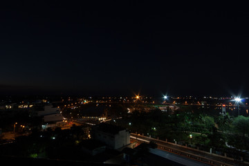 Fototapeta na wymiar Cityscape. Night scene, glittering lights from tall buildings in the capital.