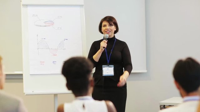 speaker with microphone at business conference