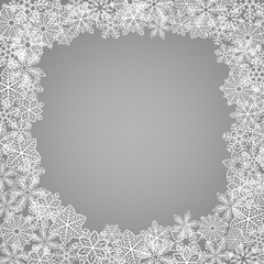 Winter frame Frame made of fluffy snowflakes on soft gray background with falling snow.
