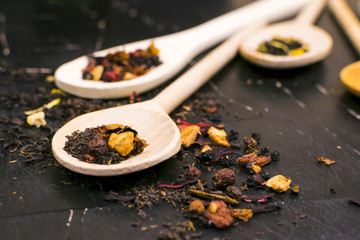 Tea in wooden spoons, lemon
