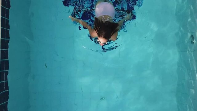 Beautiful Young Woman in Swimming Pool. Aerial View