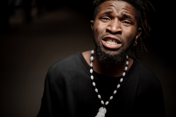 Emotional close up portrait of african american guy