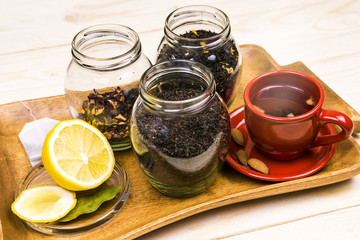 Citrus tea with lemon and biscuits on a wooden tray. Breakfast, morning.