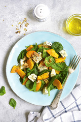 Pumpkin salad with spinach,blue cheese and nuts.Top view.