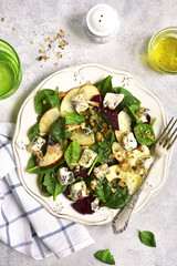 Autumn beet root salad with blue cheese,apple,,spinach and walnut.Top view.