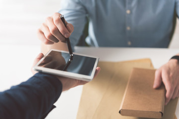 Young man is confirming receipt of his order