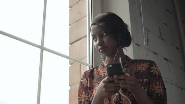 Young black woman listening music travelling looking outdoor the window, pensive - thoughtful, thinking future, music concept, african american student think about home