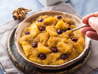 Amaranth porridge with apples, cinnamon, turmeric and dried fruit. Gluten free breakfast meal
