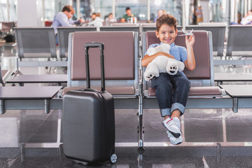 Hilarious smiling small boy in airport