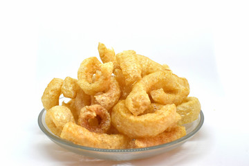 Pork cracklings on white background for traditional north Thai food concept.