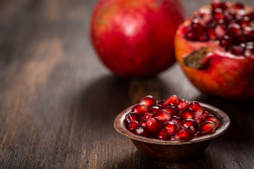 Pomegranate fruit on wooden vintage background