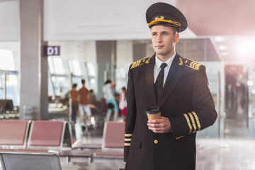 Thoughtful airman holding cup of coffee