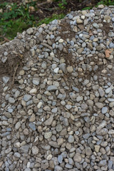 big stone heap in garden with earth for construction pile