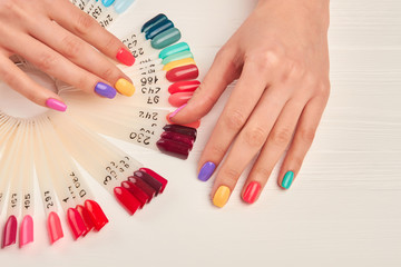 Well-groomed hands and nail color samples. Female hands with pastel manicure and nail color...