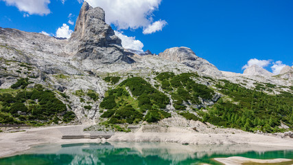 Obraz premium Glacial lake with clear cold water. Lago di Fedaia, Dolomites