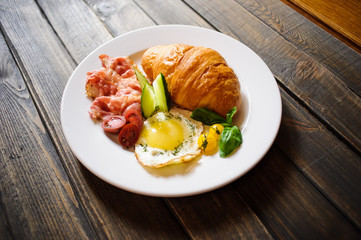 Fresh croissant with ham and salad