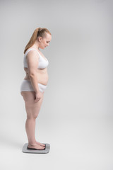 Fototapeta premium Woman standing on scales