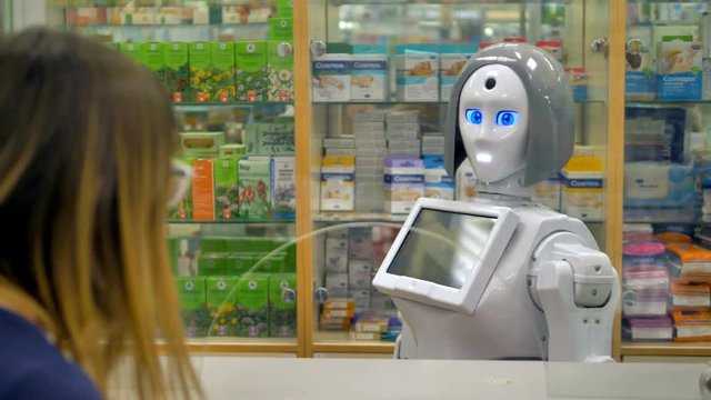 A white robot reacts to a female drugstore customer. 